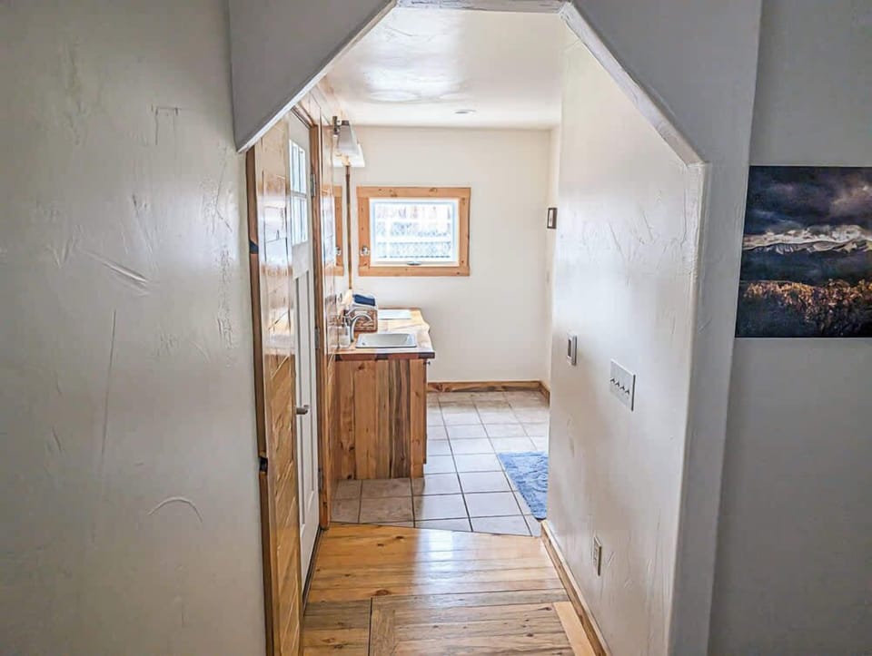 a hallway looking towards a kitchen or dining area 