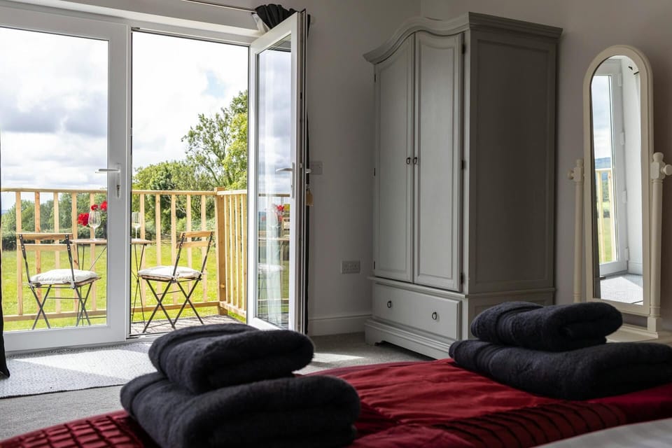 Master bedroom with a view out to the open patio doors on to the terrace.