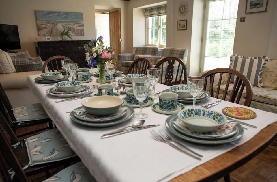 Living room with dining table laid for dinner