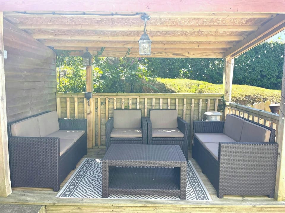 Outdoor furniture under pergola in garden