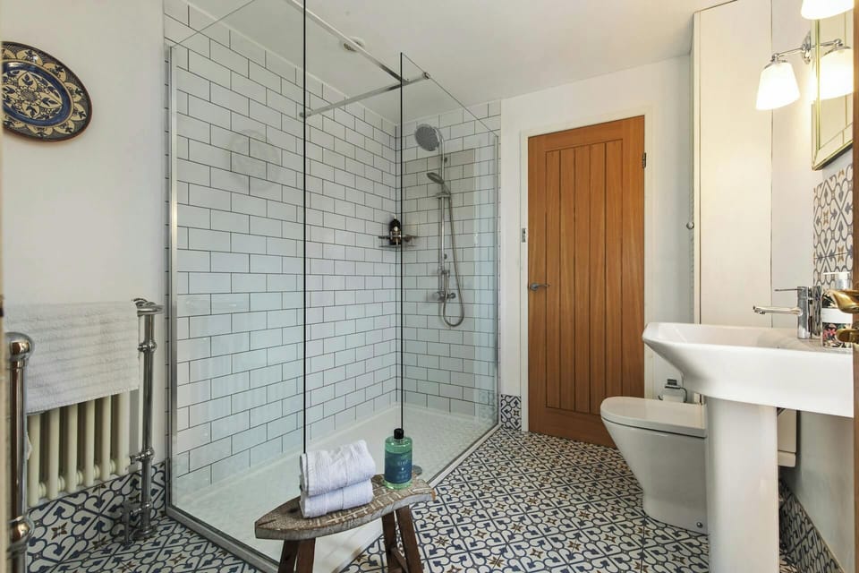 Modern bathroom with glass shower enclosure and white basin