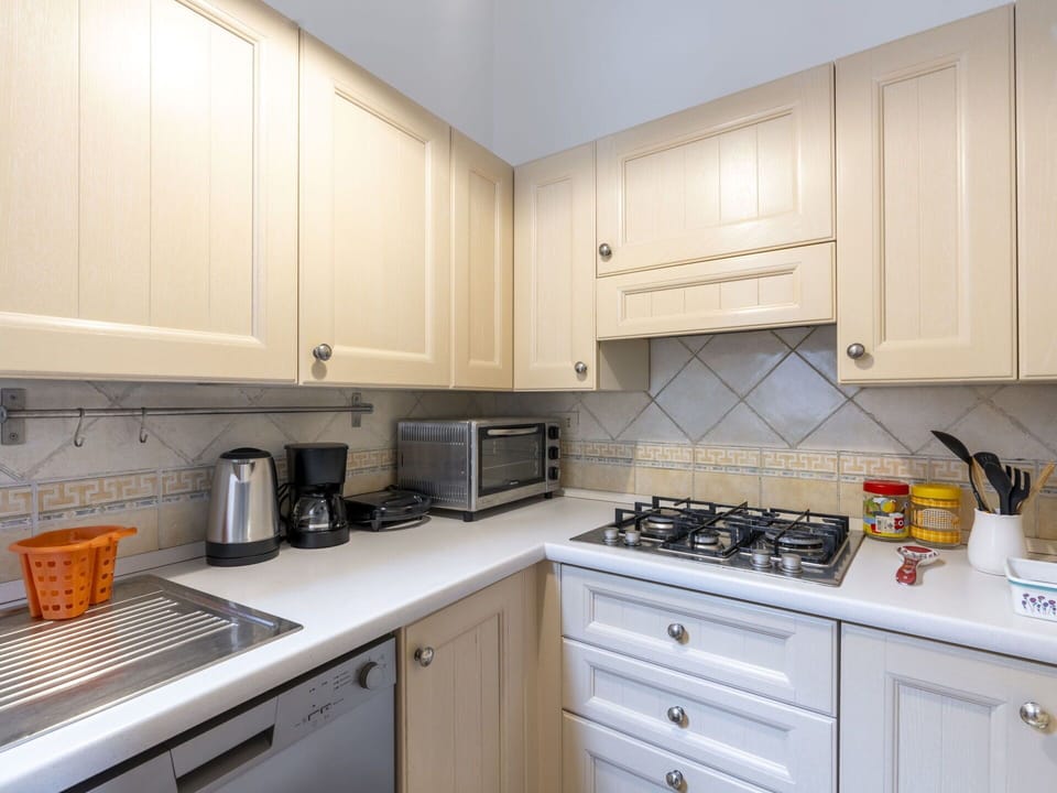 Cabinetry, Countertop, Building, White, Kitchen Appliance, Kitchen Sink, Kitchen, Kitchen Stove, Cooktop, Drawer