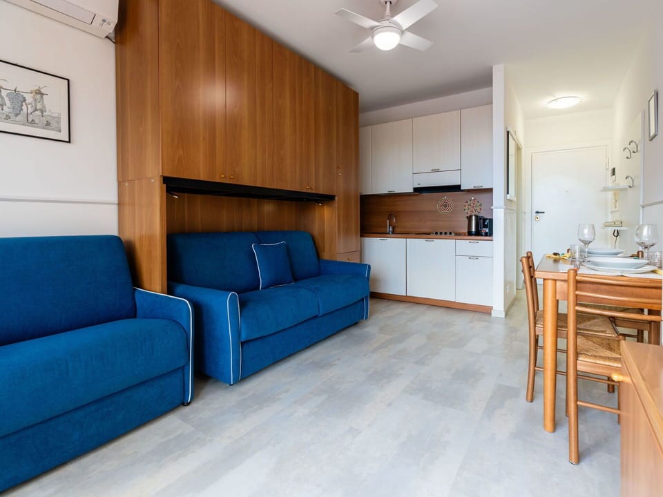 Furniture, Couch, Azure, Cabinetry, Interior Design, Comfort, Wood, Ceiling Fan, Flooring, Living Room