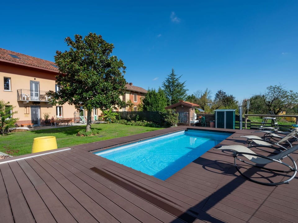 Sky, Plant, Building, Window, Tree, Shade, Swimming Pool, Outdoor Furniture, House, Urban Design