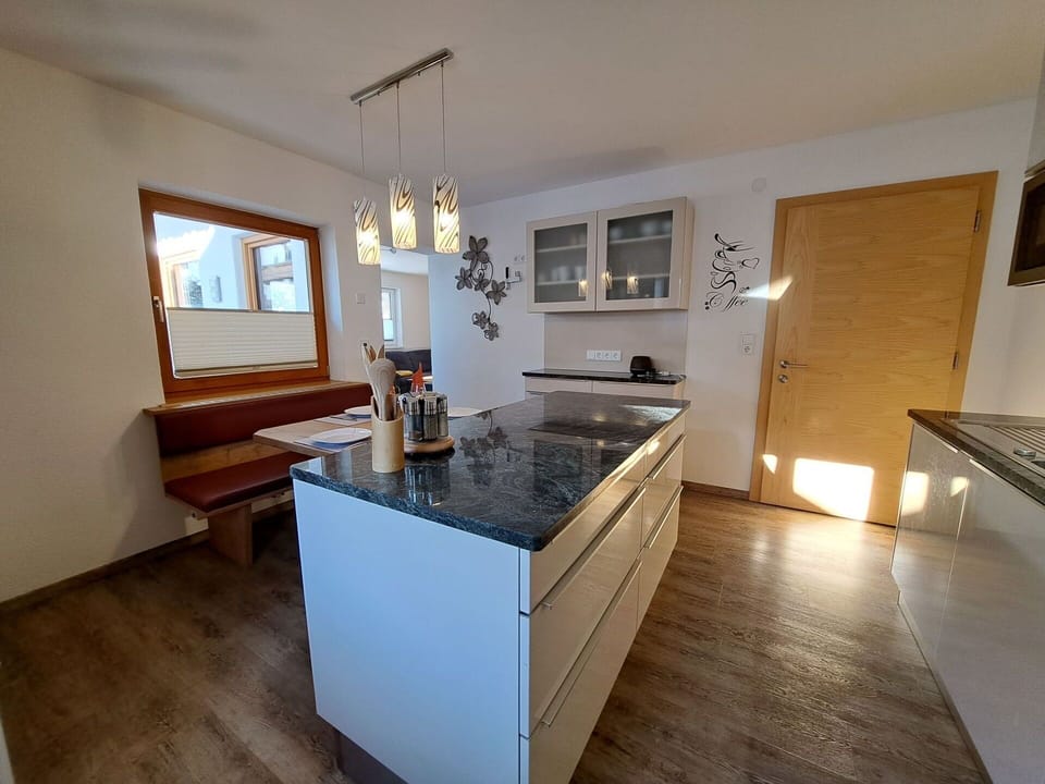 Cabinetry, Countertop, Wood, Lighting, Flooring, Kitchen Stove, Interior Design, Picture Frame, Floor, Kitchen
