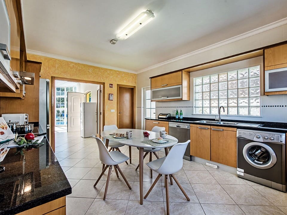 Furniture, Cabinetry, Countertop, Table, Wood, Kitchen, Interior Design, Kitchen Appliance, Chair, Kitchen Stove