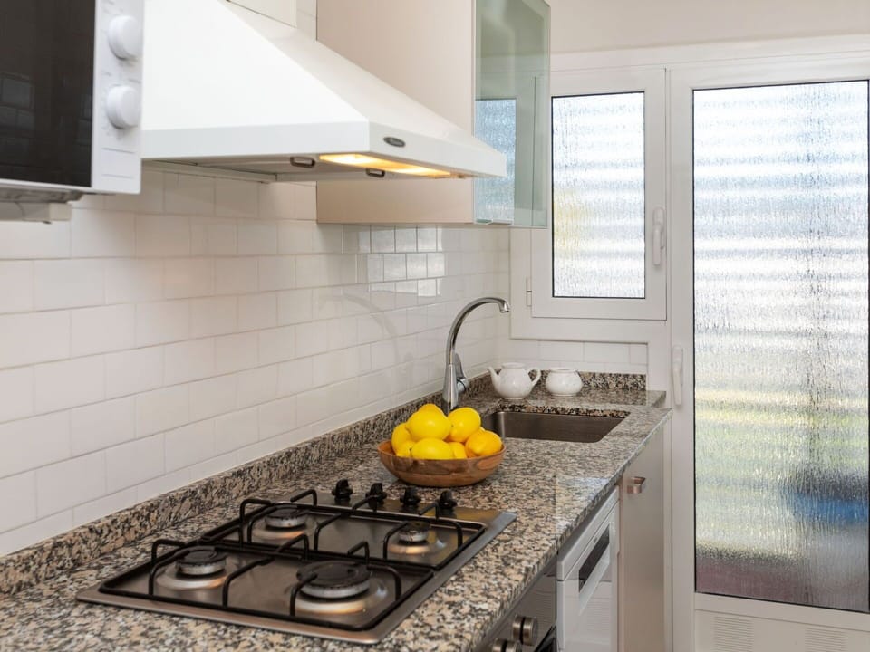 Countertop, Property, Cabinetry, Gas Stove, Kitchen, Kitchen Stove, Kitchen Appliance, Cooktop, Exhaust Hood, Building