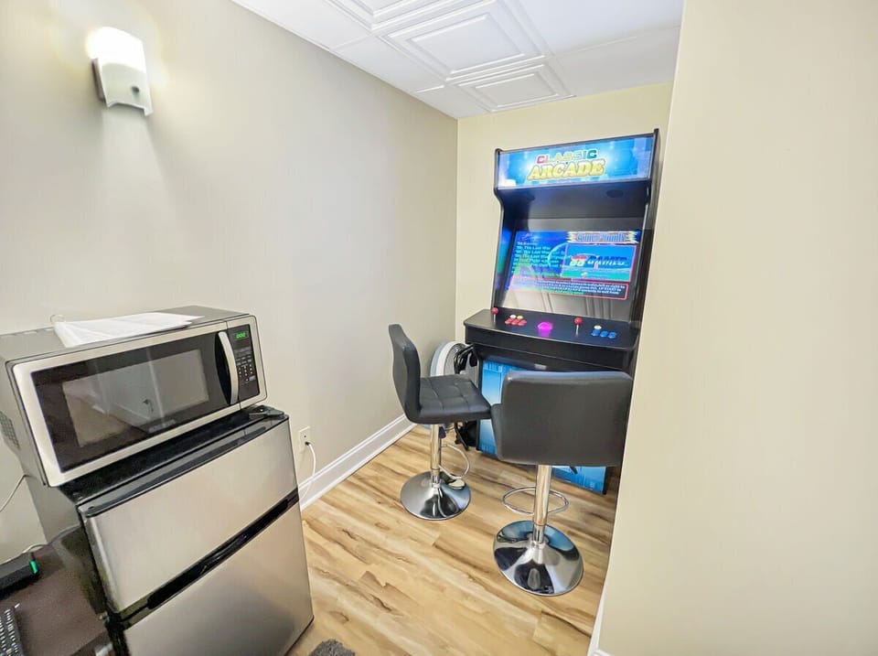 With an arcade game, a microwave, and a dorm room refrigerator