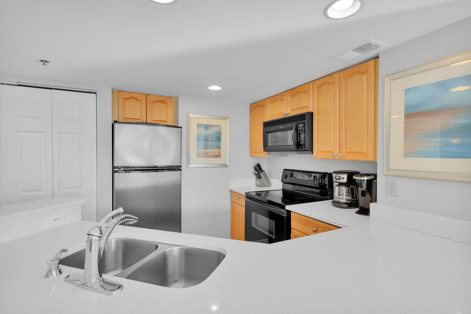 Fully stocked kitchen with 2 barstools.