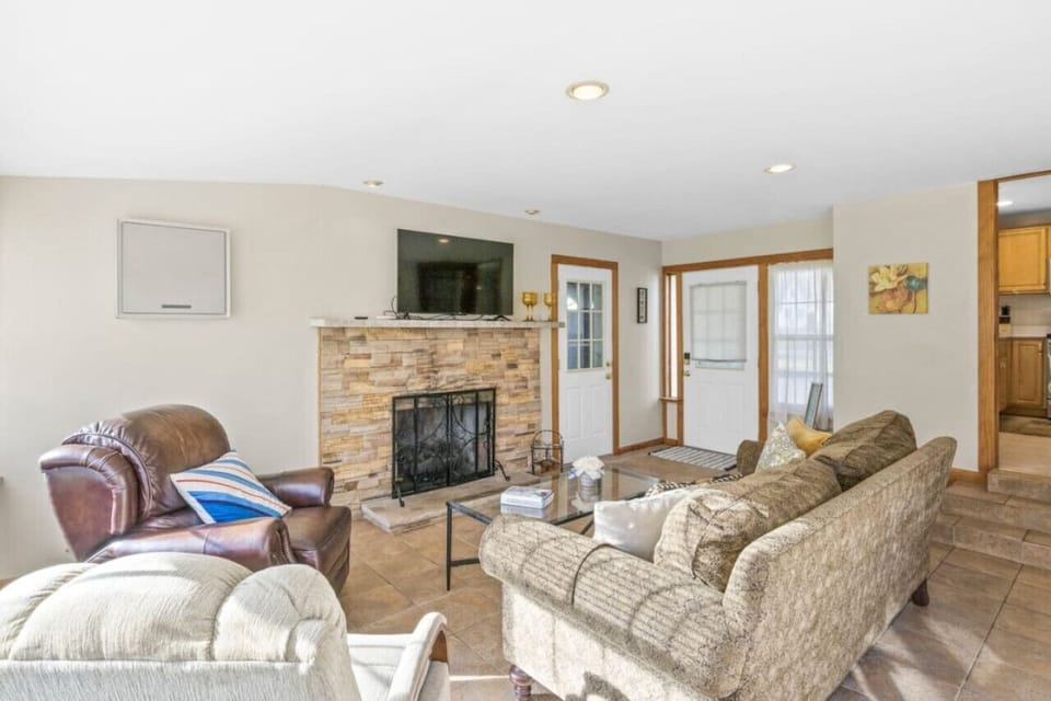 Another view of sunroom with gas fireplace and  smart TV