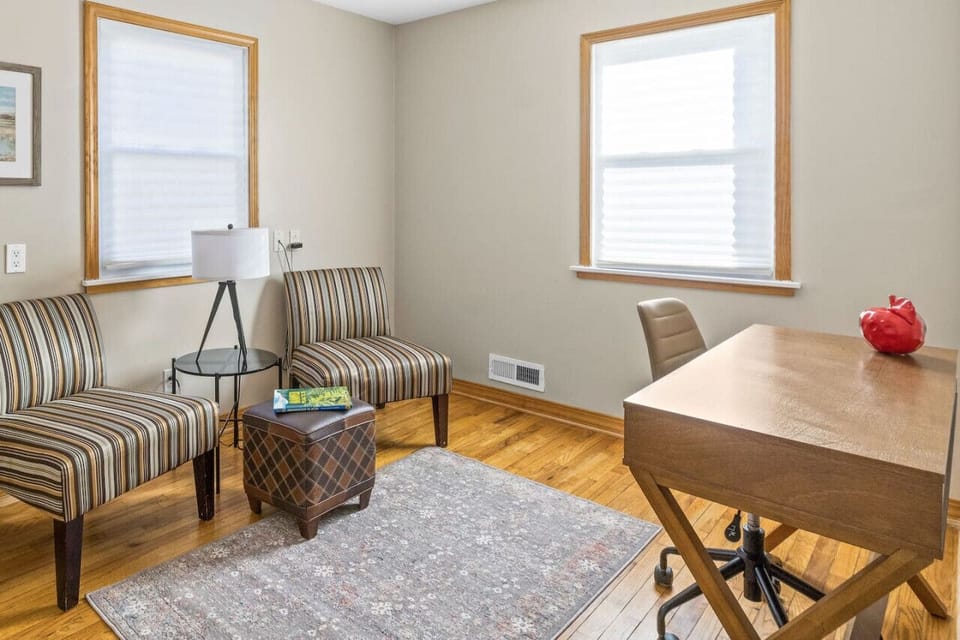 Home office: dedicated work space with desk in bright sunlit room, located on main floor.