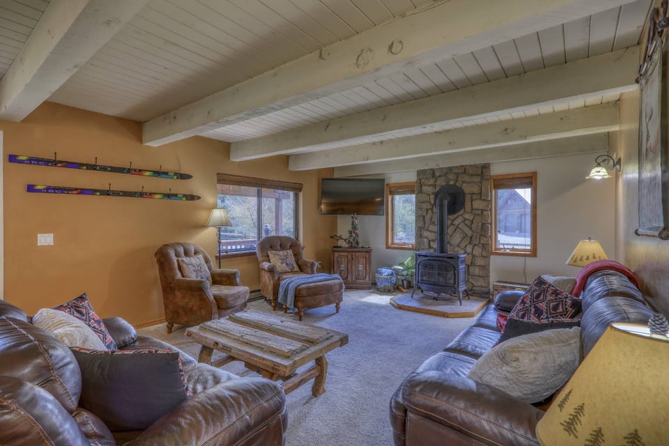 Warm and rustic family room located on the main floor. This home sleeps 10- Located 10 miles from uptown amenities & 10 min. to the heart of downtown.
