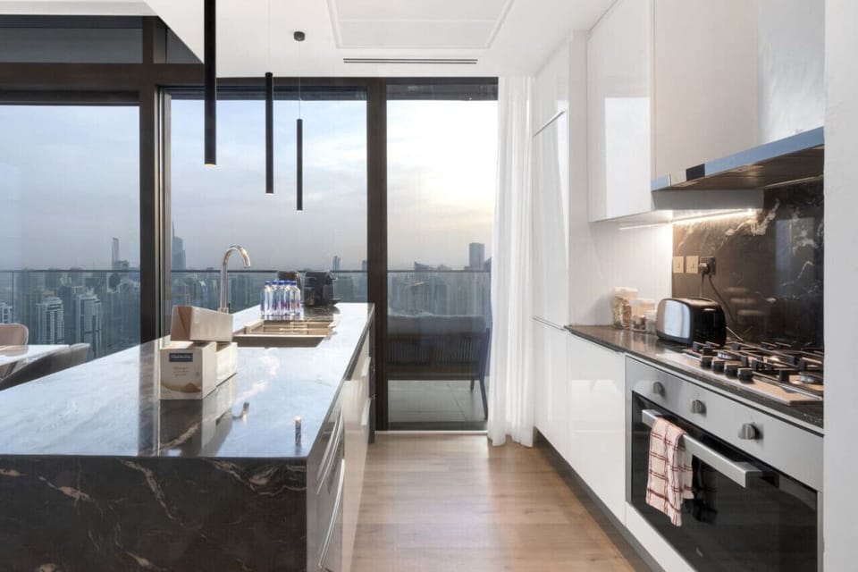 Gourmet Kitchen: Sunlit space with skyline views, modern appliances, and stylish decor await you!