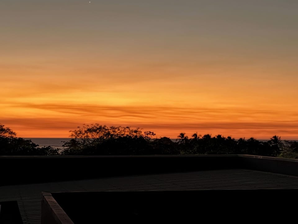 Stunning sunset colors over Tamarindo Costa Rica, capturing the vibrant coastal atmosphere. Perfect way to end the day near this centrally located condo, just steps from the beach, restaurants, and Tamarindo nightlife.