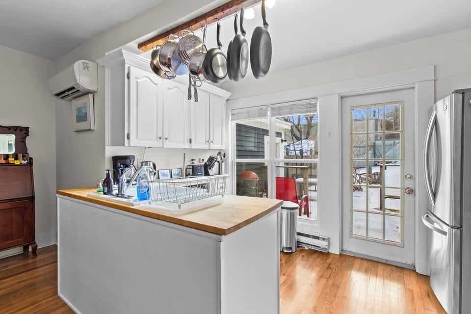 The fully equipped kitchen features direct access to the back deck for easy indoor-outdoor living.