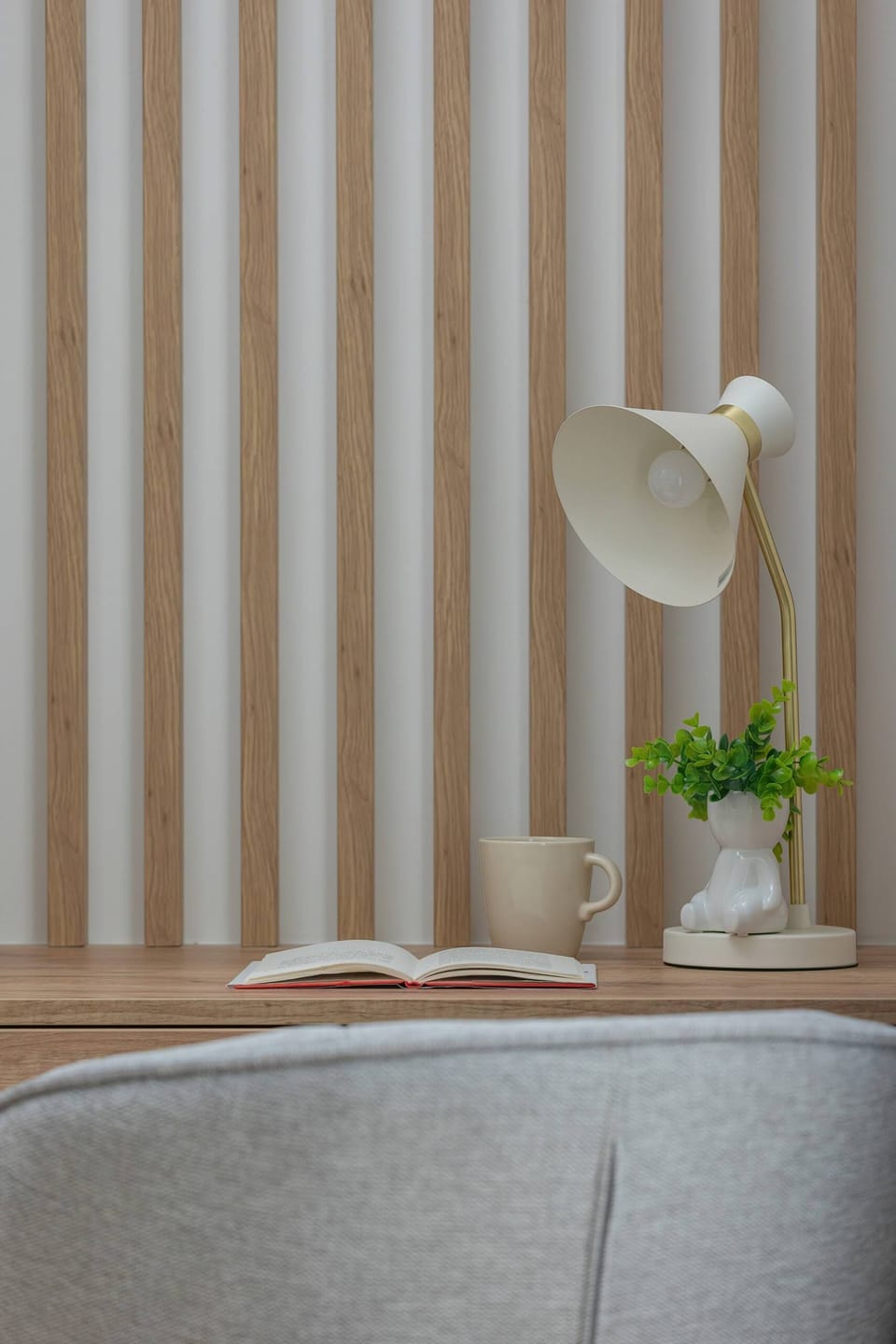 A close-up of a desk with a comfortable chair, ideal for remote working.