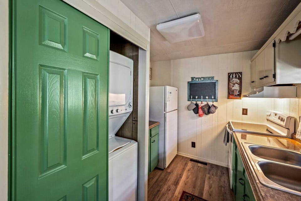 The fully equipped kitchen area also includes the laundry behind the closet doors.