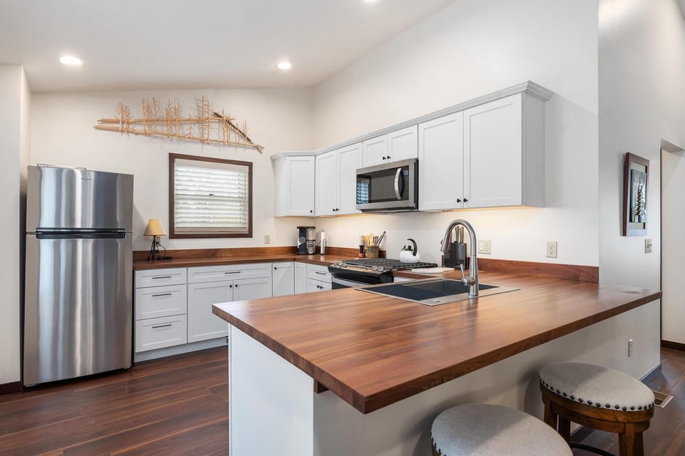 Kitchen with Wood Countertops and Two Barstools