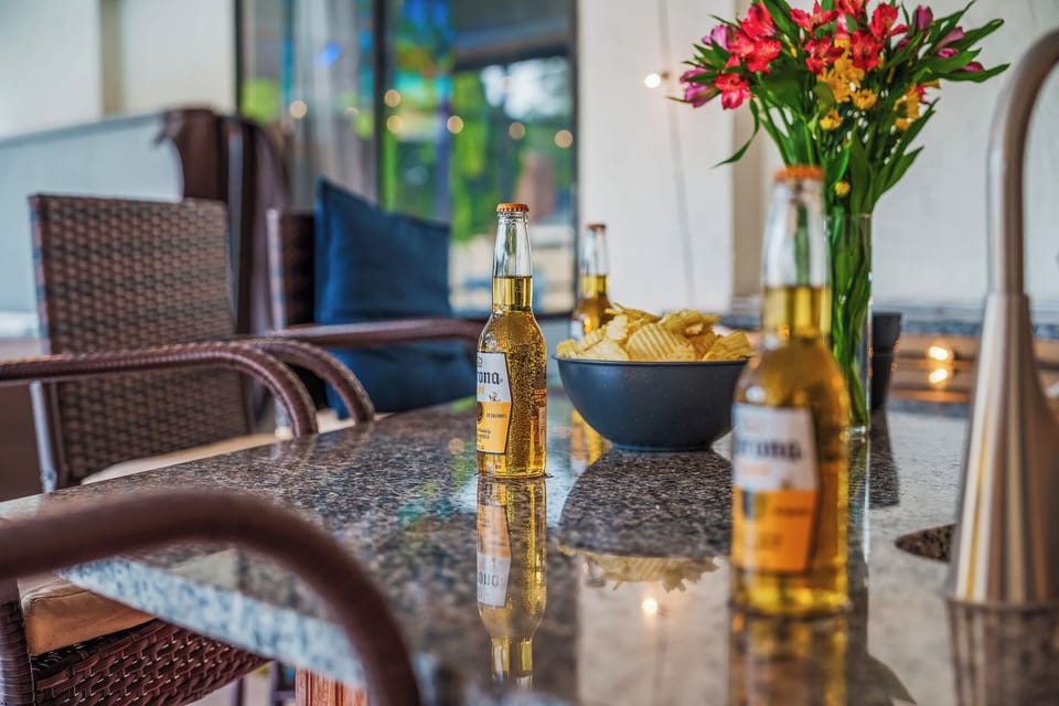 Crack open a cold one at the wicker patio table with chips and fresh flowers close at hand.