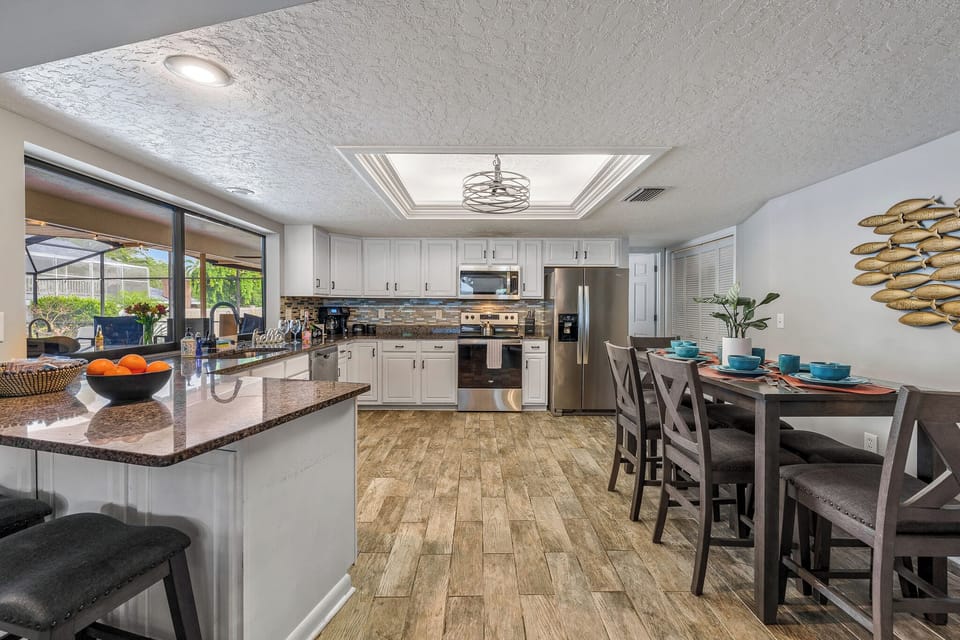 Gather the whole crew around the granite island in a kitchen built for real family cooking, stainless appliances and all.