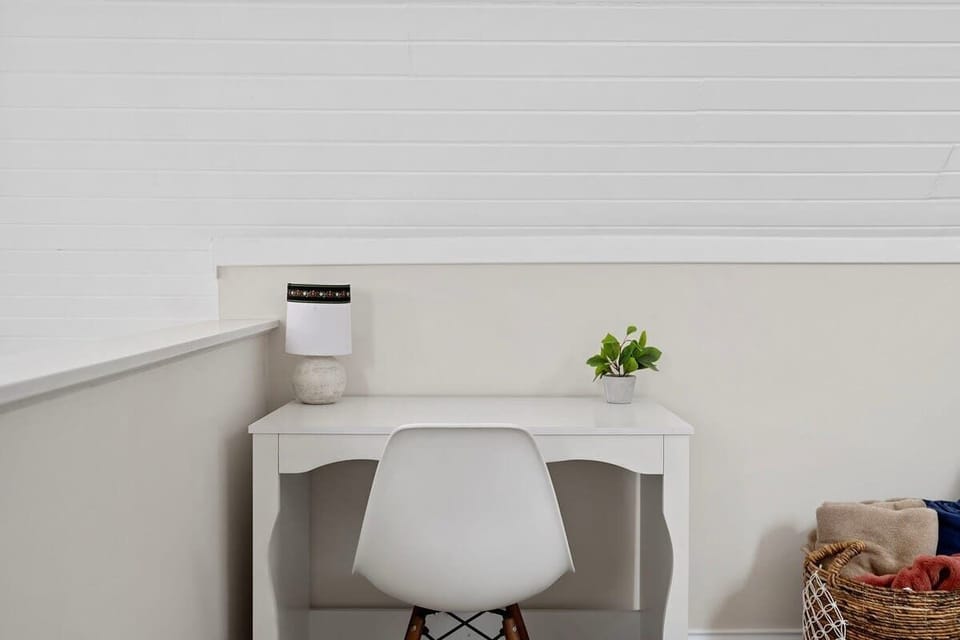 The upstairs has a family room area with a cute desk or laptop space.