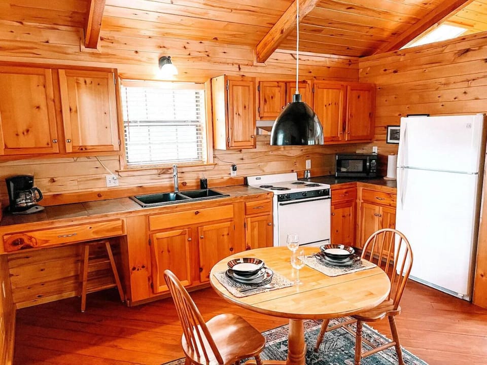 Cook your favorite meals in the fully equipped kitchen, complete with modern appliances, a coffee maker, microwave, and ample counter space. The adjacent dining area offers a cozy spot for enj