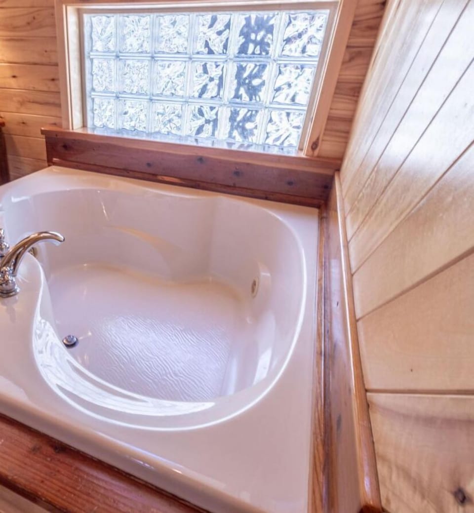 Indulge in the ultimate relaxation at Hidden Haven with the luxurious spa bathtub. Perfect for unwinding after a day of adventure, this feature is nestled in a cozy corner of the cabin, offeri