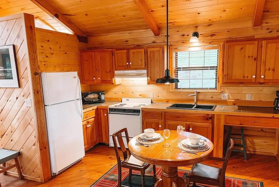Cook and dine in a cozy, well-lit kitchen that offers all the essentials for a home-cooked meal. The natural wood finishes and ample light create a warm and inviting space to enjoy meals toget