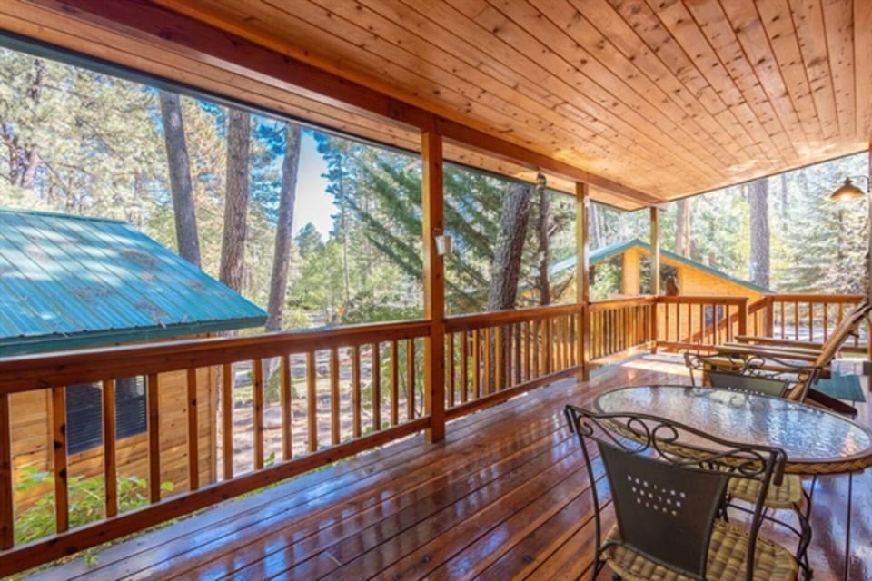 Welcome to our inviting front porch, adorned with comfortable seating, where you can relax and soak in the serene surroundings, embracing the beauty of outdoor living.