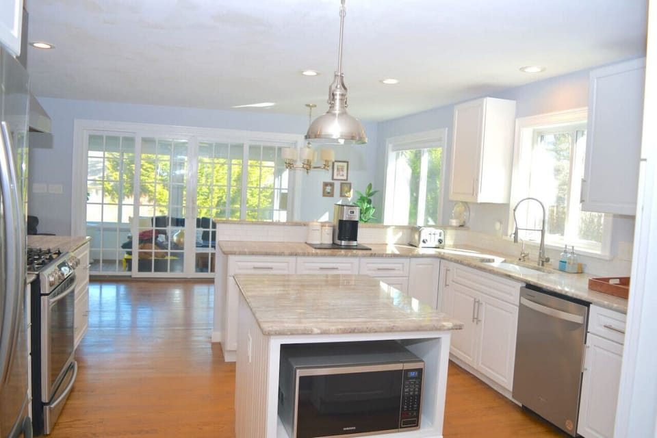 Kitchen with Center island, marble and stainless appliances.  There is also water filtration for drinking water
