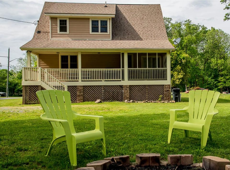 Expansive backyard with chairs and fire ring


