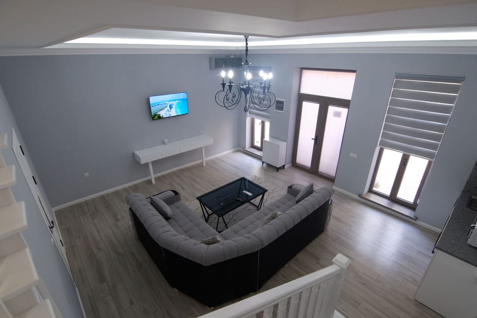 Family Quadruple Room, Pool View | Living area | 1000-cm Smart TV with digital channels