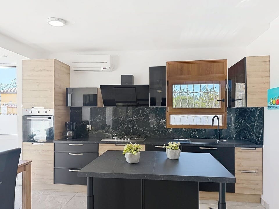 Furniture, Countertop, Kitchen, Interior Design, Flooring, Cabinetry, Wood, Kitchen Appliance, Floor, Chair