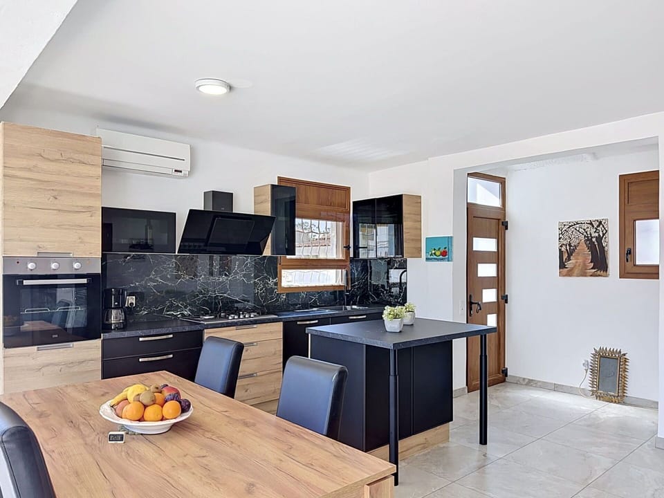Furniture, Interior Design, Flooring, Kitchen, Countertop, Floor, Cabinetry, Wood, Room, Chair