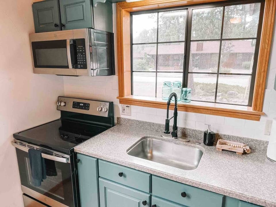 Efficiency meets culinary creativity: Kitchen equipped with oven and microwave for your convenience.