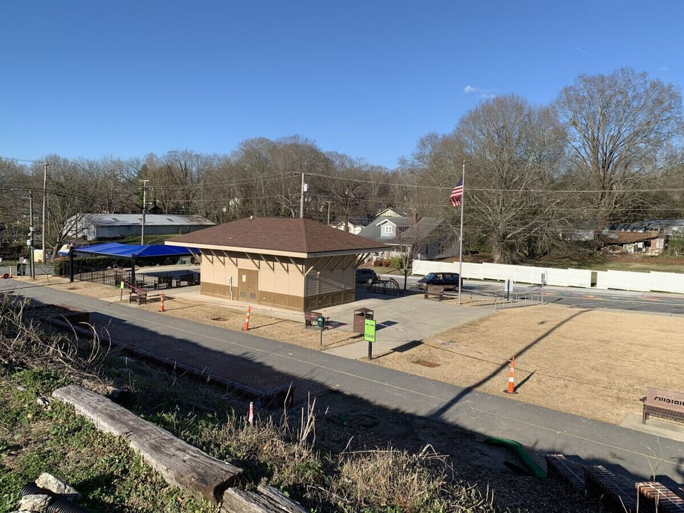 Park Across Street - Splash Area (Blue Cover), Bathrooms, and Green Space