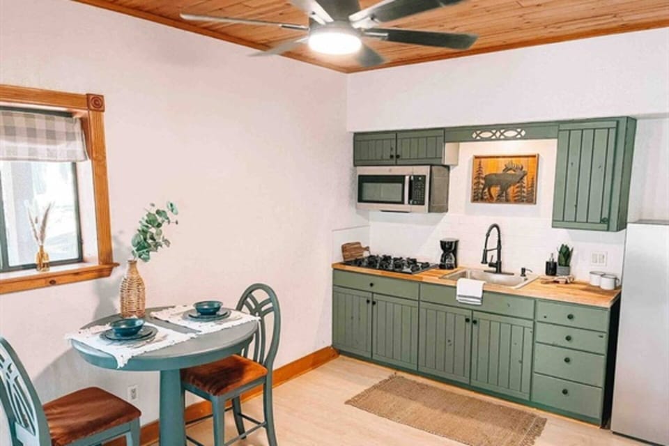 Fully stocked kitchen, including pots, pans, spices, dishes, and coffee.
