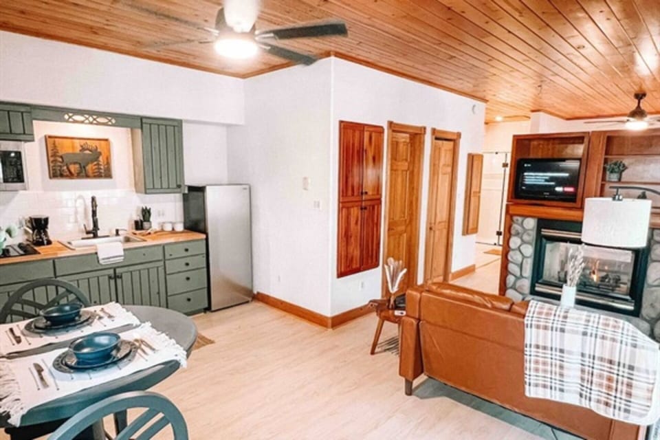 All-in-One Retreat: Kitchen, Dining, Living - Cozy Fireplace View.