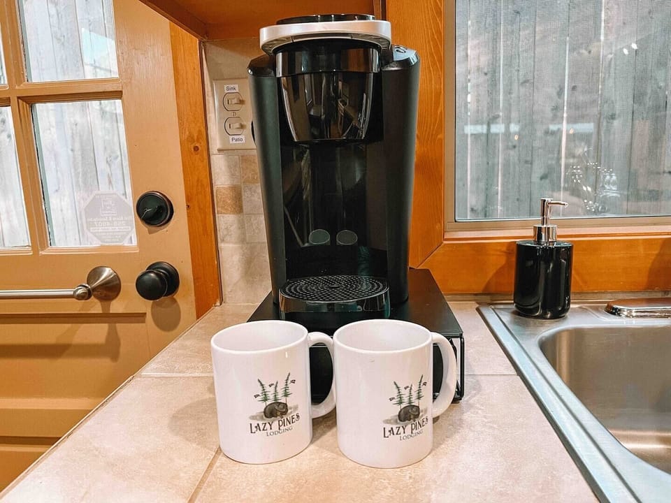 Start your day right with the perfect cup of brew in the comfort of your own cozy cabin. Let the aroma of freshly brewed coffee fill the air as you embrace the tranquility of nature.