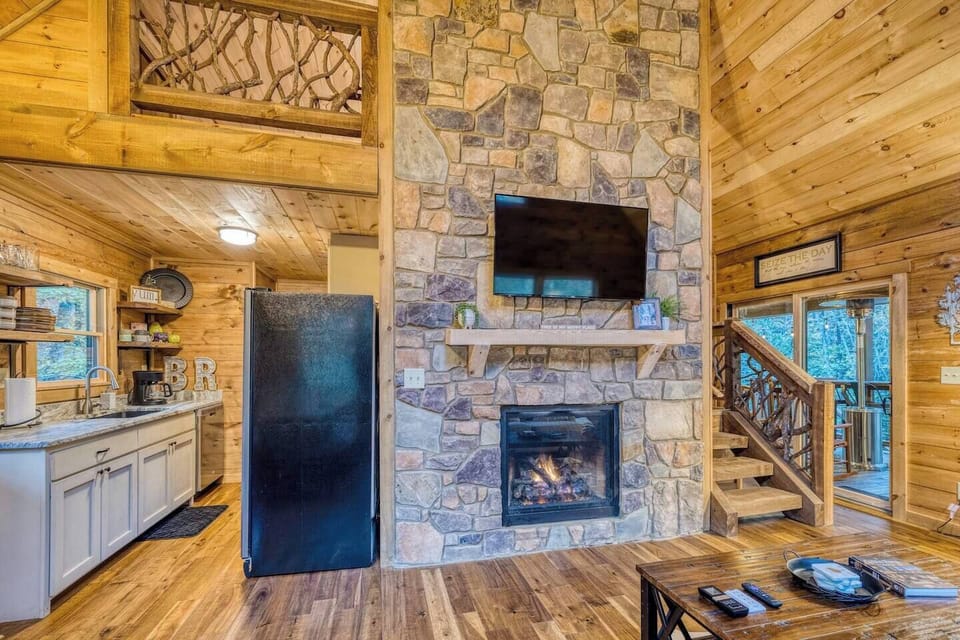 Enjoy a view of our TV area, with a glimpse of the adjacent kitchen, where the heart of our home beats with both savory delights and captivating entertainment