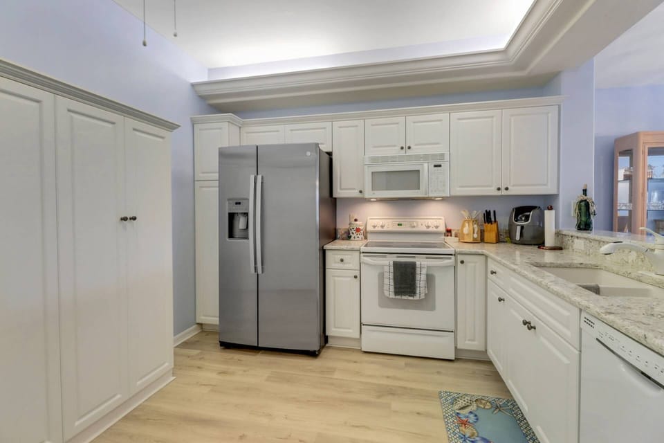 The kitchen is well equipped with full size oven, microwave, refrigerator/freezer, dishwasher and pantry..