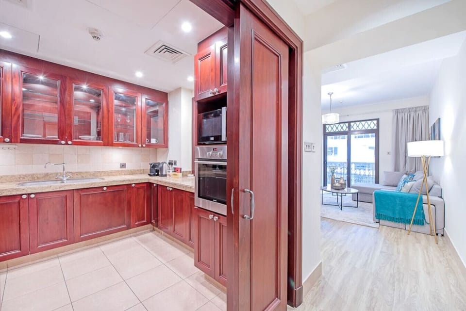 Kitchen & Lounge: Elegant wood cabinetry meets bright natural light for delightful meals and moments!