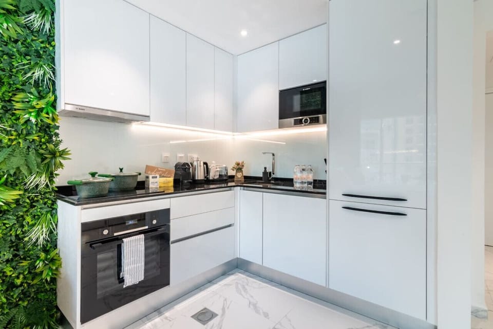 Sleek Kitchen: Bright, modern design with lush greenery, perfect for culinary creativity!