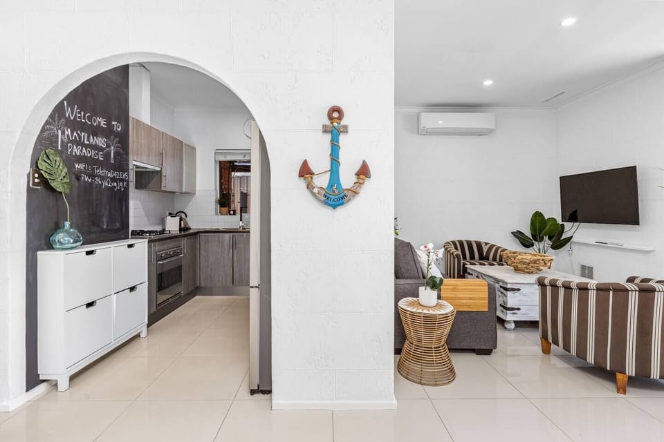 View of the inviting living room connected to the functional kitchen, offering comfort and convenience.