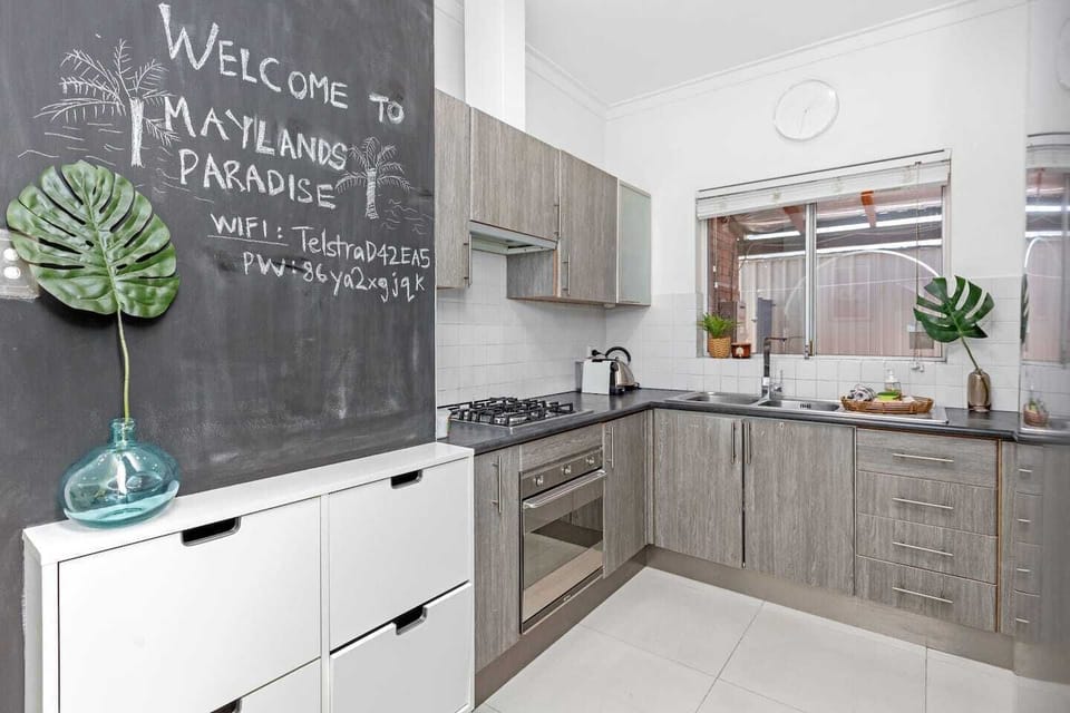 Cook with ease in our modern kitchen, featuring a gas stovetop, oven, and ample counter space.