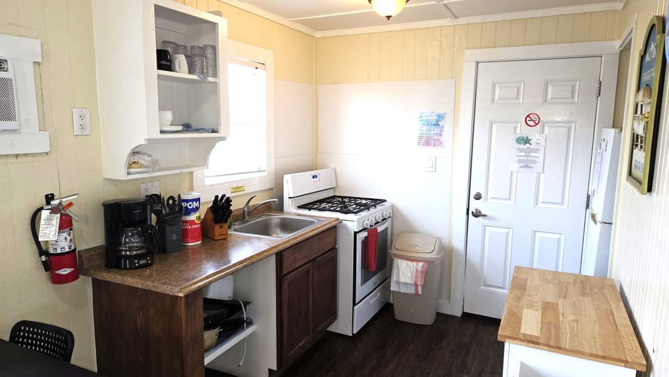 The kitchen has a gas stove, refrigerator, microwave, and drip coffee maker