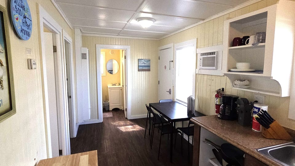 The main room also has a dining area that seats 4 guests