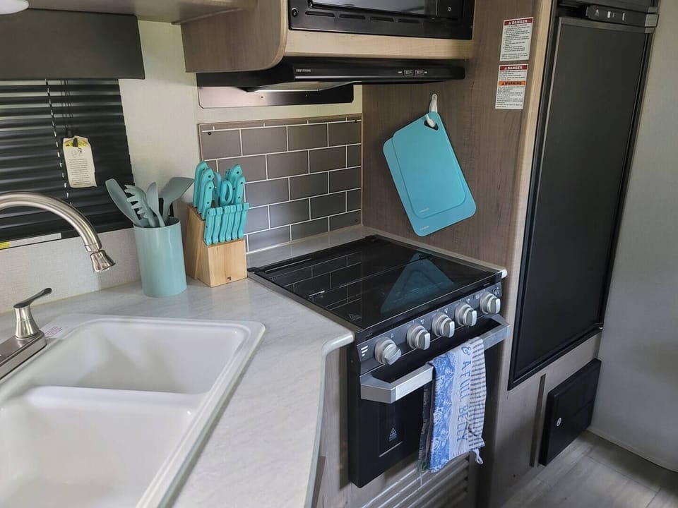 The kitchen provides a microwave, refrigerator,  coffee maker, stove, oven, dishes, and utensils. Everything you need to create a delicious meal. 