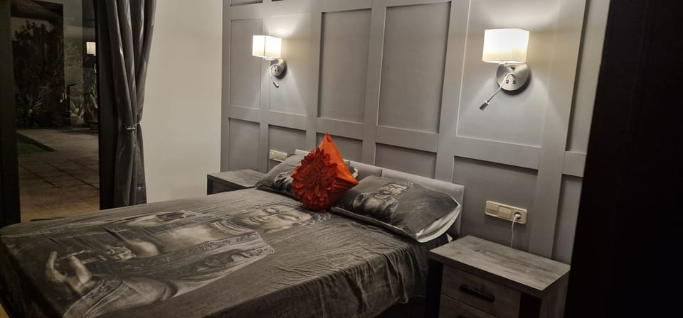 Master bedroom with patio doors leading to the private garden, with hot-tub