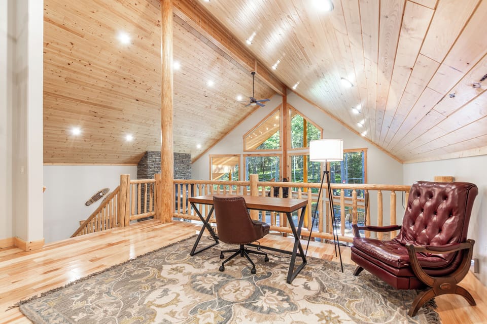 This bright loft workspace at offers a peaceful place to catch up on emails or plan your next adventure. With soaring wood ceilings, warm natural light, and views of the surrounding pines, it's the perfect “work-from-vacation” spot.